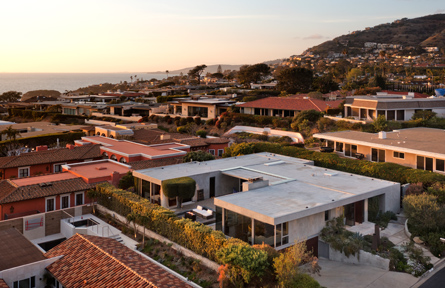 flat roofed houses close to the ocean in dusk