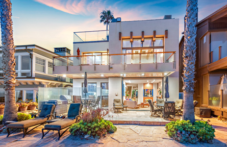 luxury home in dusk patio view with folding chairs outside